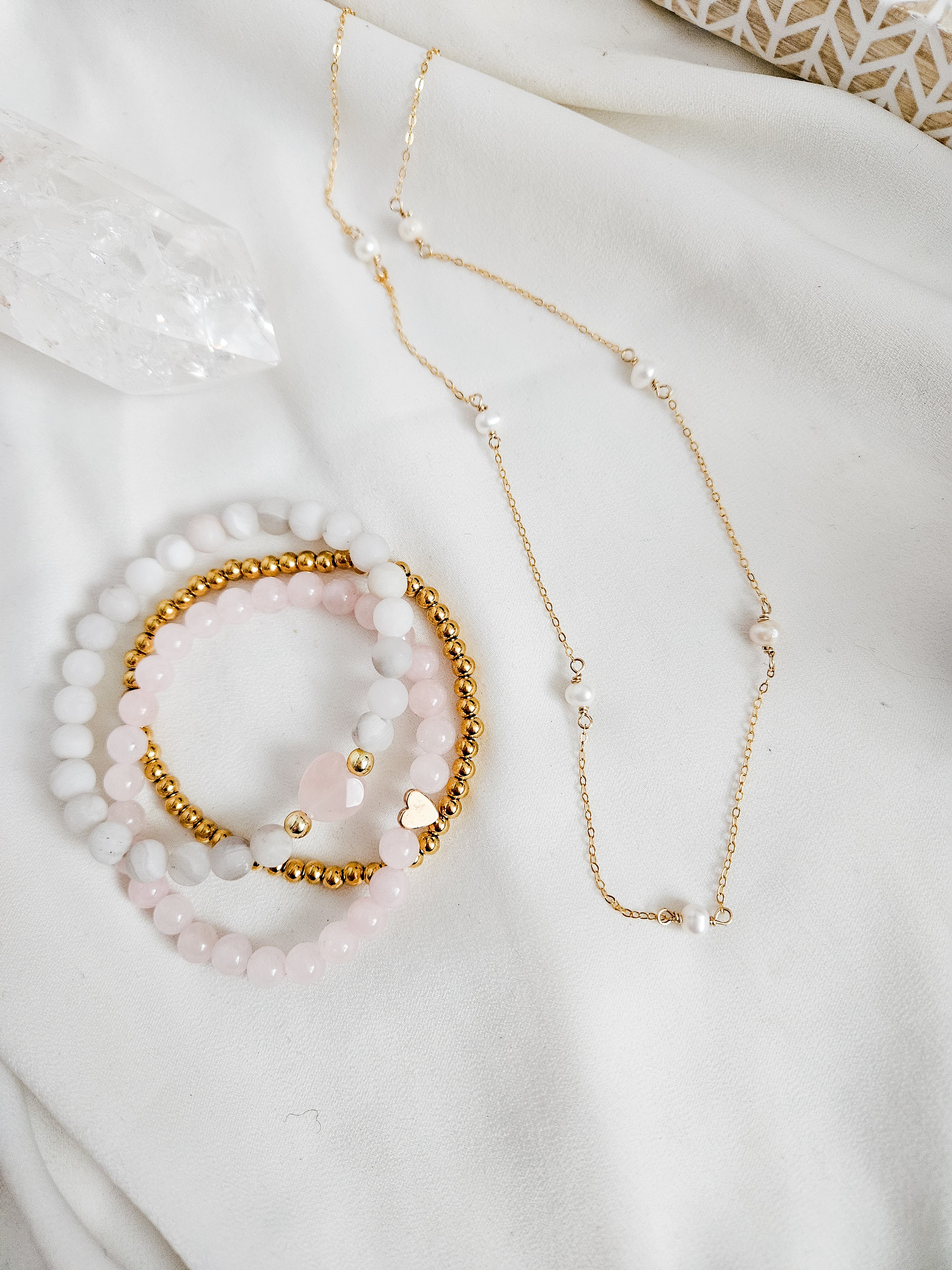 Pink and gold gemstone beaded bracelets and a dainty pearl and gold filled necklace.