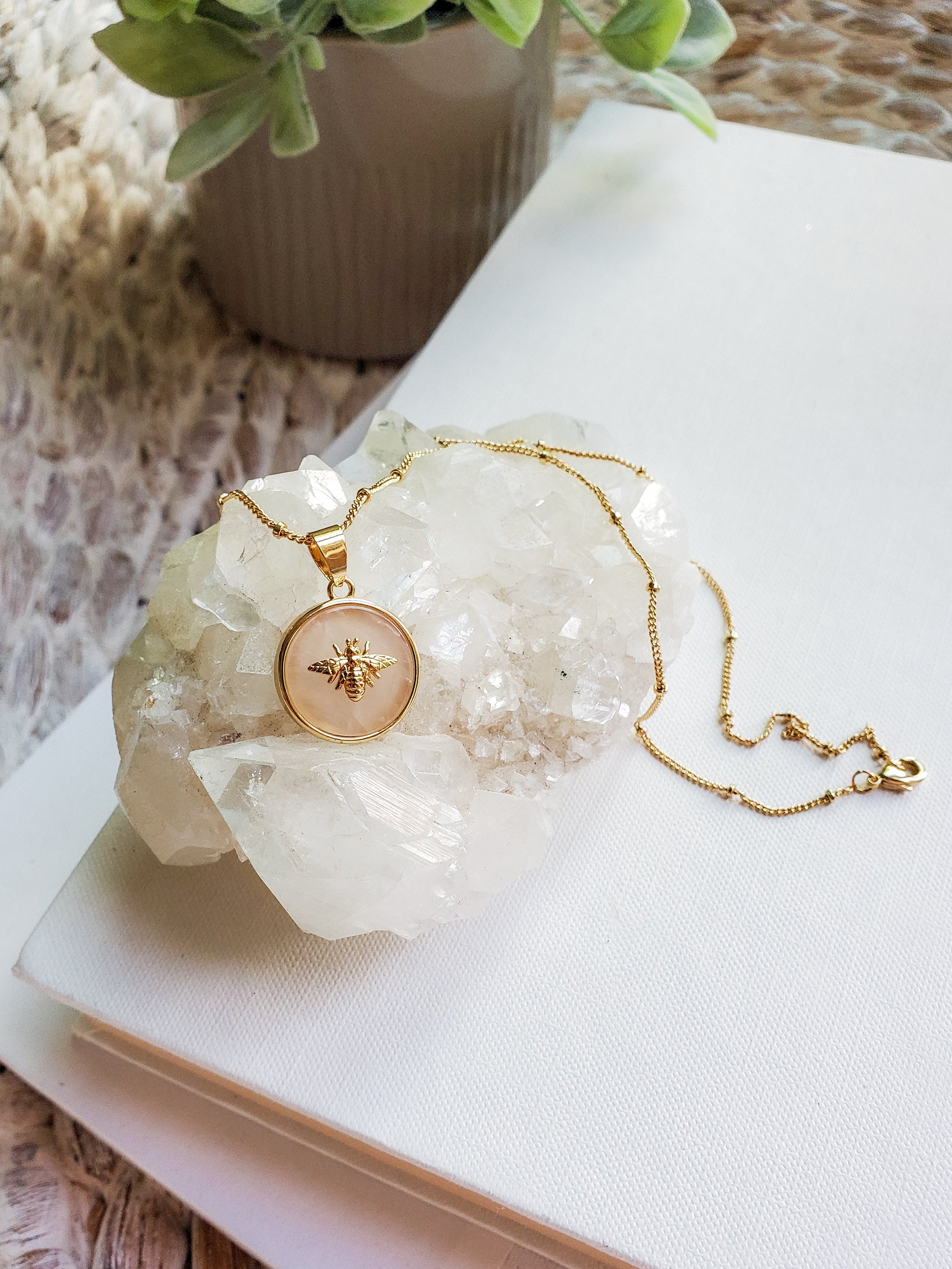 Rose quartz gemstone on Queen Bee necklace close up.